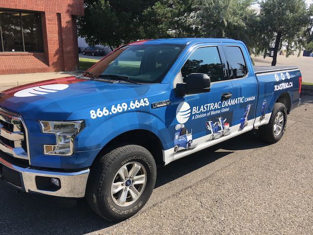 Blue vehicle wrapped truck show logo and contact info